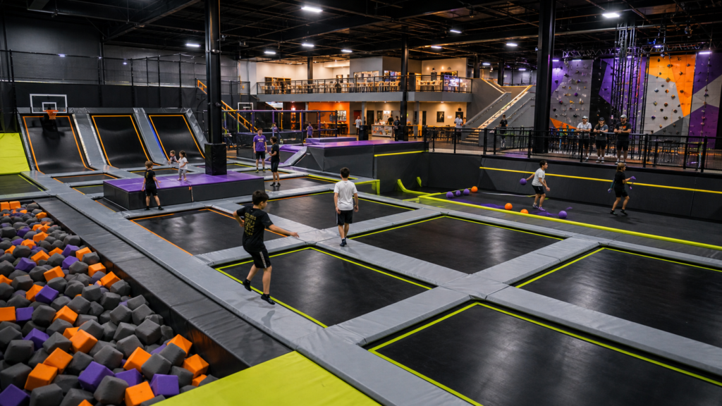 Commercial trampoline park layout with active entertainment zones and clear supervision sightlines
